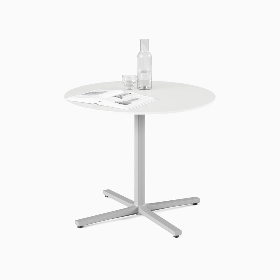 A white, round, standard height Everywhere Table with a grey column.