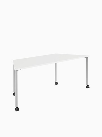 White trapezoid Everywhere Table with grey legs and castors, viewed from an angle.