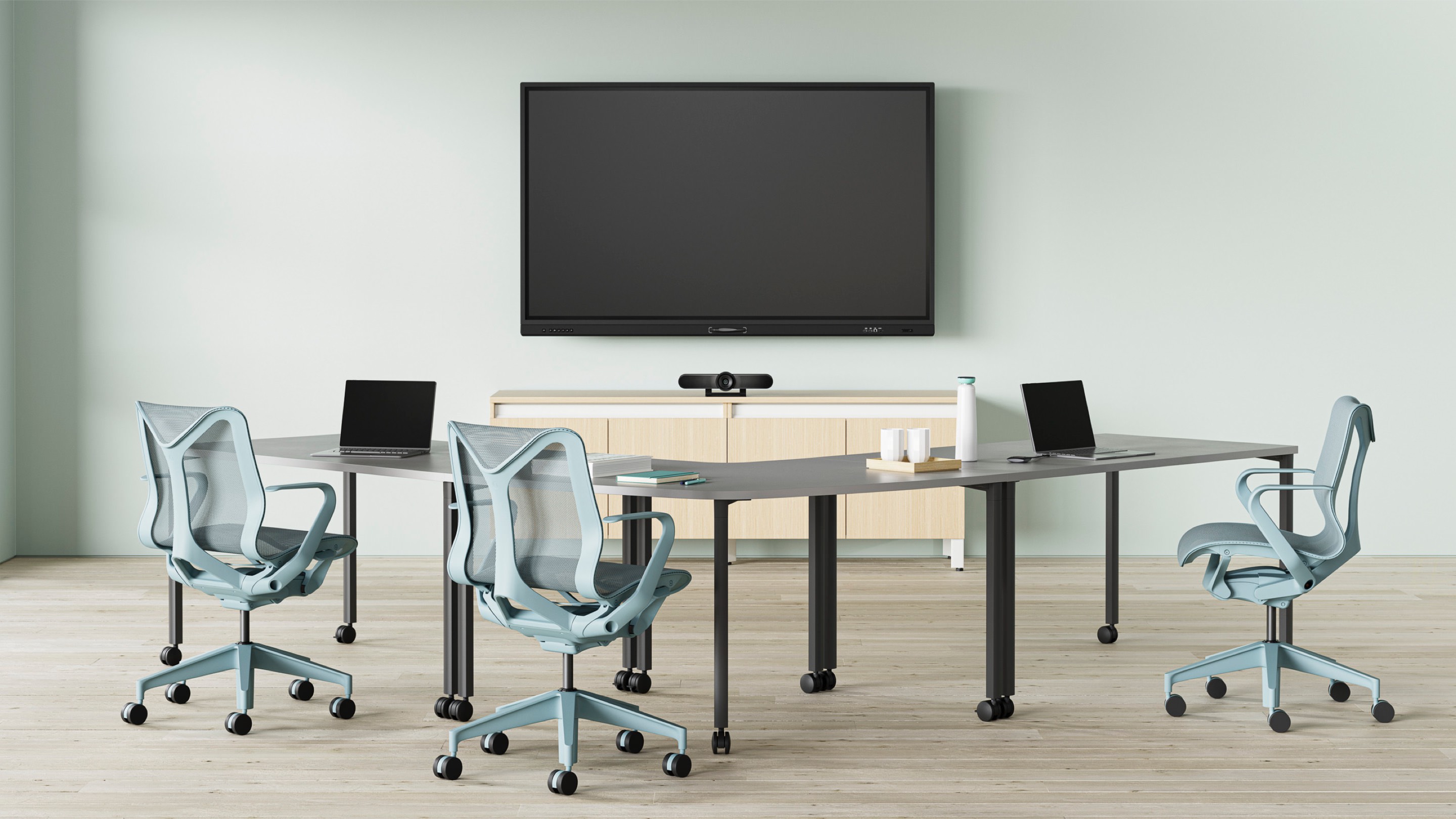 A video conference space, with grey Everywhere Tables and three glacier Cosm Chairs.