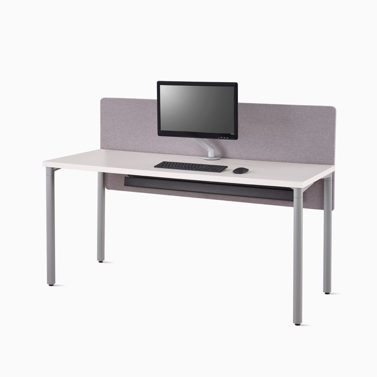 Viewed at an angle, a white Everywhere desk with a gray fabric, surface-attached privacy screen with a screen-attached cable trough below the desk.