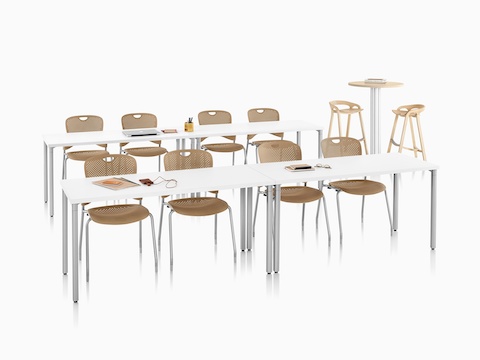 A classroom setting featuring Everywhere Tables and light brown Caper Stacking Chairs.