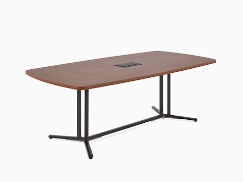 A square-edge rectangular Everywhere conference table with a medium walnut woodgrain laminate top and central power access, viewed at an angle.