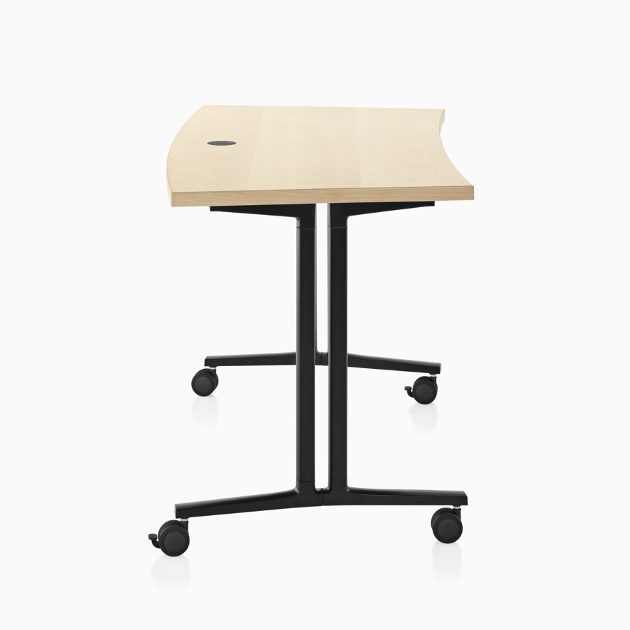 Side profile of an Everywhere Classroom Table with a curved, square edge, ash veneer top, and a black, T-leg base with casters.