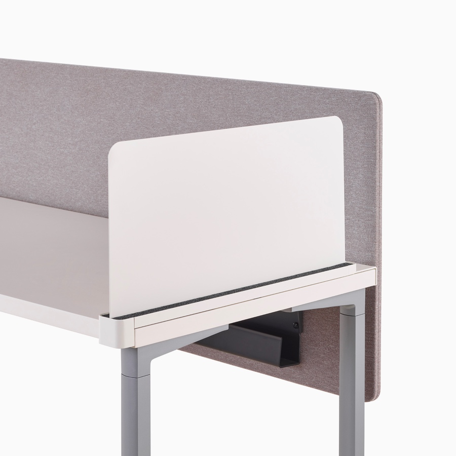 Close-up of a white Ubi slim metal delineation side screen with a cable trough found attached to a privacy screen beneath an Everywhere Table.