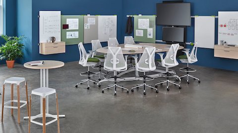  Sayl office chairs surround an Exclave table in an open collaboration space.