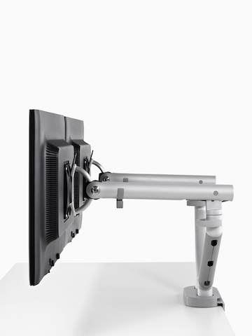 Side-by-side monitors supported by a Flo Dual Monitor Arm.