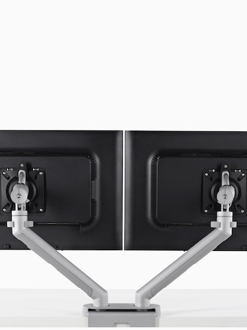 Side-by-side monitors supported by a Flo Dual Monitor Arm. Select to go to the Flo Dual product page.