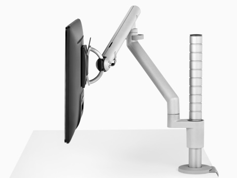 Profile view of a monitor attached to an adjustable Flo Modular monitor arm.