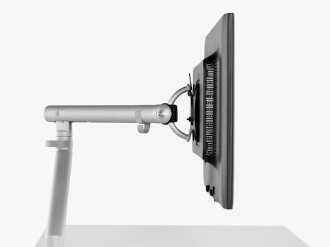 Profile view of a single monitor supported by an adjustable Flo Monitor Arm.