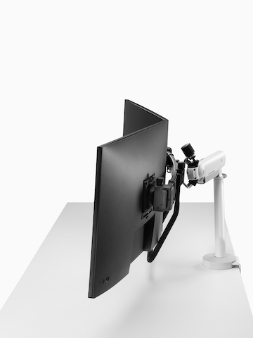 White dual Flo X monitor arm set up with 32'' screens, viewed from the side. Select to go to the Flo X Dual product page.
