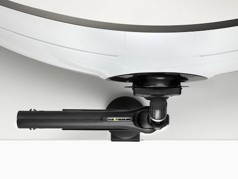 Black Flo X multi-monitor arm with an attached wide-screen adaptor holding a screen, viewed from the top.