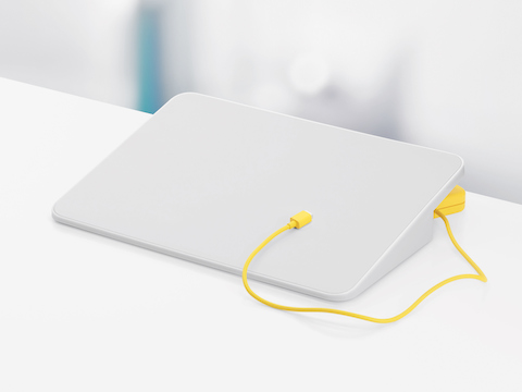 Een witte Formwork-mediastand en een gele oplaadkabel.