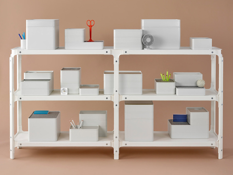 Several Formwork desktop storage elements on a three-shelf Magis Steelwood Shelving System.