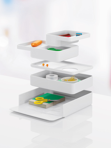Five Formwork desktop storage elements, each seemingly hovering above another. Five Formwork desktop storage elements, each seemingly hovering above another.