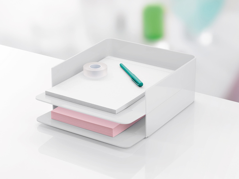 Two white Formwork Paper Trays stacked one on top of the other and containing paper, tape, and a pen. Two white Formwork Paper Trays stacked one on top of the other and containing paper, tape, and a pen.