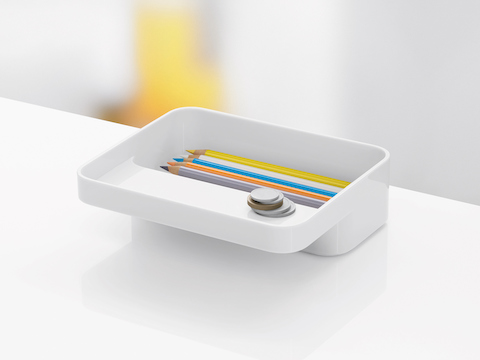 The small version of a white Formwork Tray, with pencils in the rear compartment and coins on the cantilevered ledge. The small version of a white Formwork Tray, with pencils in the rear compartment and coins on the cantilevered ledge.