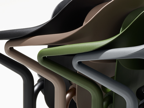 A close-up view of nested Fuld Chairs in different colours.