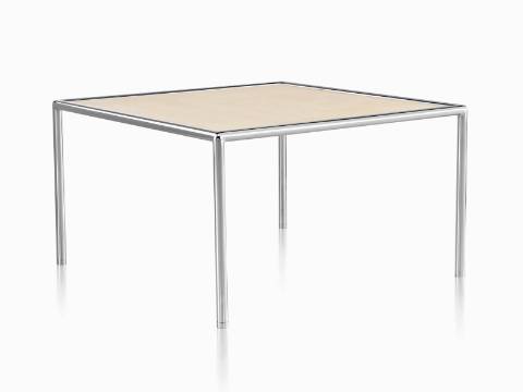 Una mesa   completa redonda con una tapa de color tostado y un marco de metal tubular.