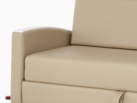 Detail view of a Gemma Double Sleep Sofa in tan textile with white arm caps.