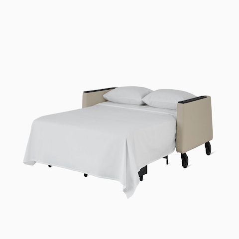Gemma Sleep Settee in sleeping position, dressed with sheet. 