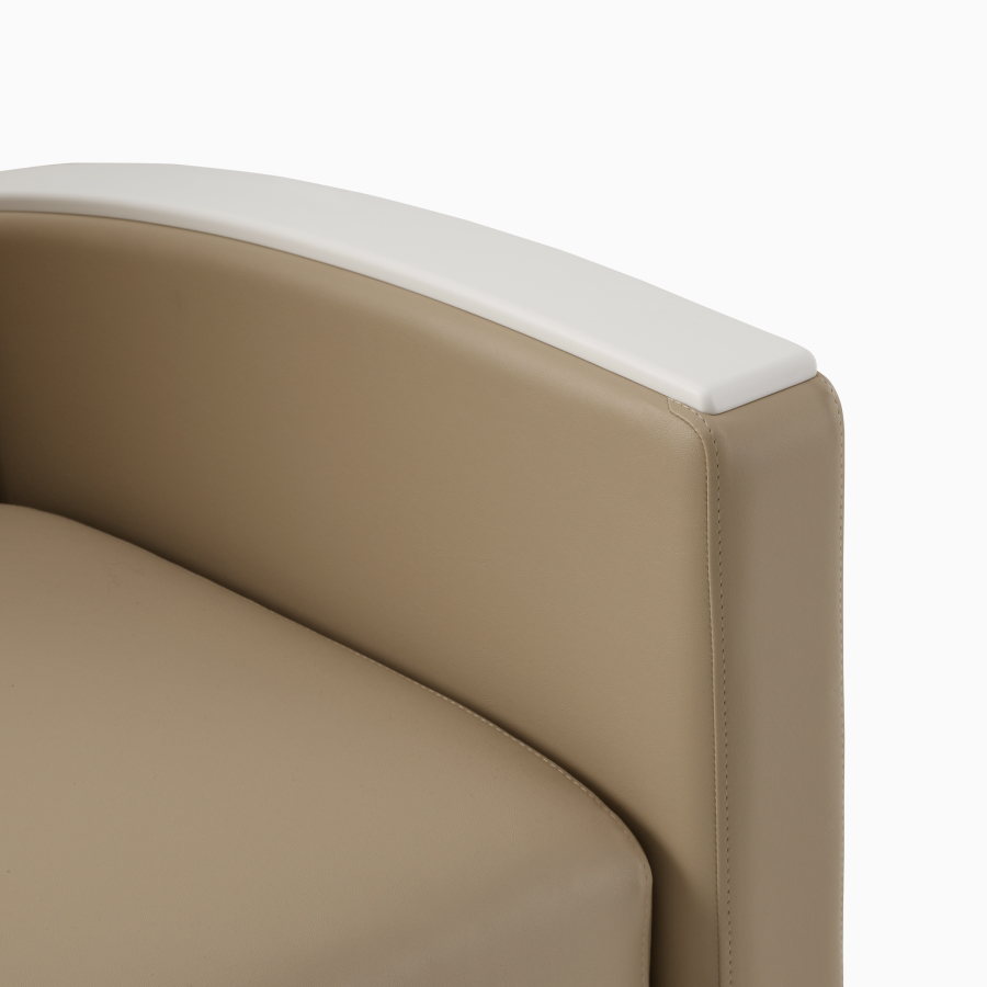 Detailed view of curved white armrest. 
