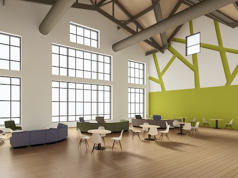 An open area setting featuring Genus round tables surrounded by Eames Molded Plastic Chairs and Chadwick Modular Seating.