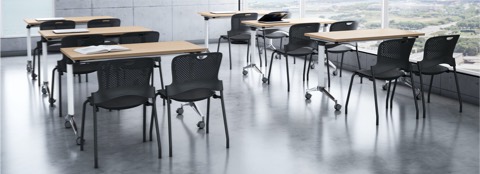 A training room setting featuring a Genus flip-top tables with Caper stacking chairs.