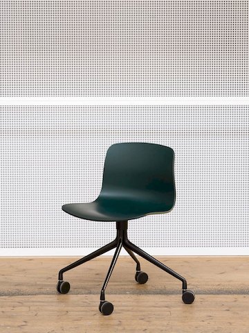 Green, 4-star black swivel base About A Chair, standing alone against a wall.