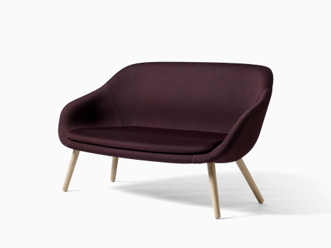 A maroon About A Lounge Sofa. A maroon About A Lounge Sofa.