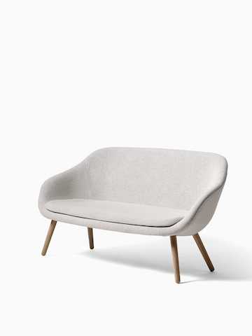 A gray About A Lounge Sofa with wooden legs, viewed at an angle. Select to go to the About A Lounge Sofa product page. 
