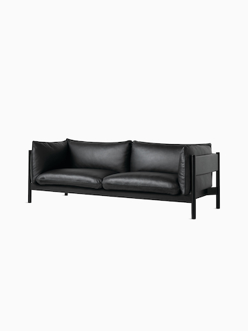 A front angle view of a black leather Arbour Sofa.
