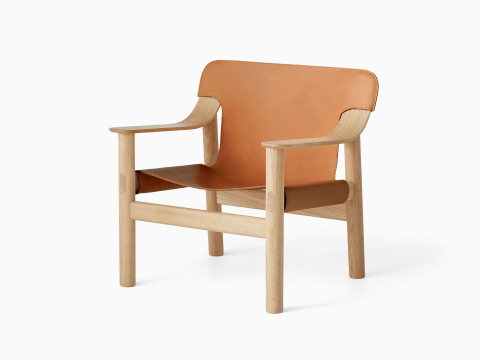 A front angle view of the Bernard Lounge Chair with oak frame and cognac leather seat and back. A front angle view of the Bernard Lounge Chair with oak frame and cognac leather seat and back.