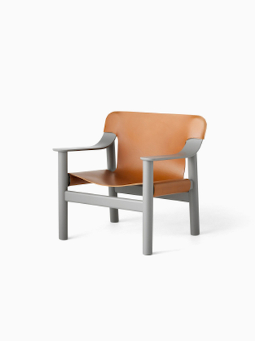 A front angle view of the Bernard Lounge Chair with grey frame and cognac leather seat and back.