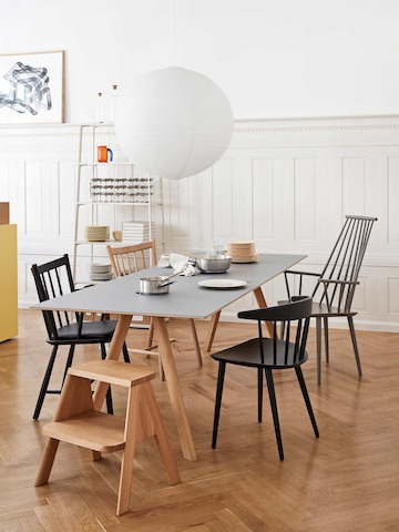 A Copenhague Dining Table with black J 41 Chairs and a Butler Step Stool.