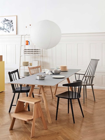 A Copenhague Dining Table with a Butler Step Stool next to it.