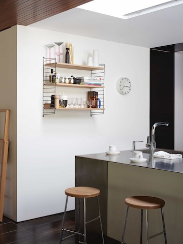 String Wall Shelving in Kitchen with two oak seat and chrome leg base Cornet Barstools.