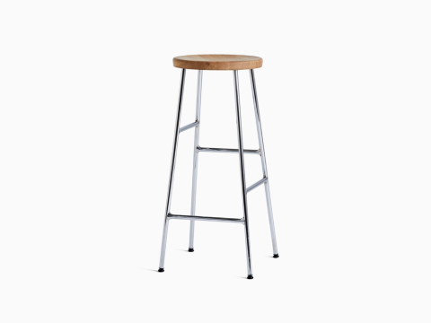 A front angle view of the Cornet Barstool with oak seat and chrome leg base.