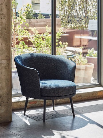 A dark blue Dorso Lounge Chair.