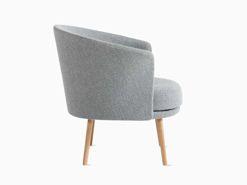 A side view of a Dorso Lounge Chair in grey with oak dowel legs.