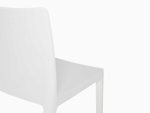 A close up view of the back of a white Élémentaire Side Chair.