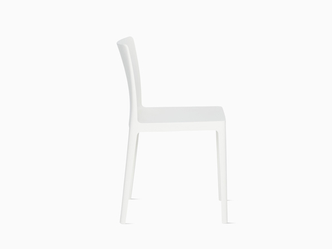 A cream white Élémentaire Side Chair viewed from the side.