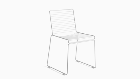 A three quarter angle view of a white Hee Dining Chair.