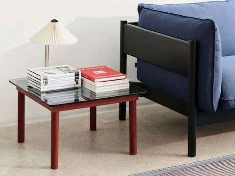 A square Kofi Coffee Table positioned next to an Arbour Sofa.