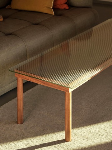 A rectangular Kofi Coffee Table positioned next to a Quilton Sofa.