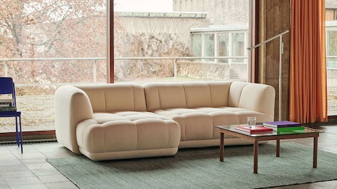 A square Kofi Coffee Table positioned next to a Quilton Sectional Sofa.