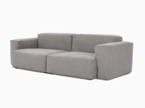 A front angle view of the Mags Soft 2-seat Sectional Sofa in grey.