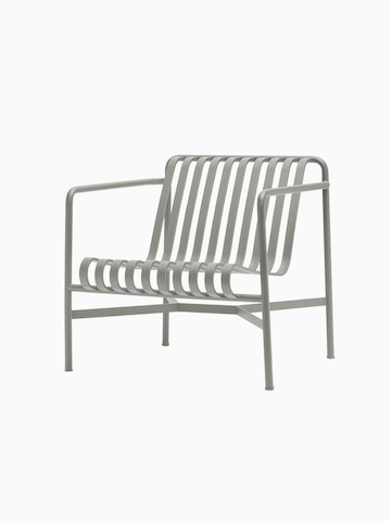 A three quarter view of a Palissade Lounge Chair, Low in light grey.