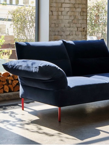A navy blue 2-seat Pandarine Sofa with reclining armrests.