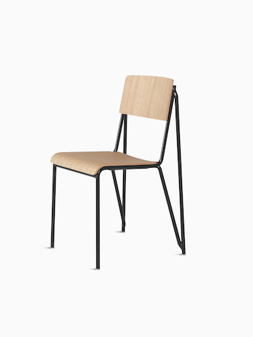 A three quarter side view of the Petit Standard Chair with oak seat and back, and black frame. Select to go to the Petit Standard Chair product page.