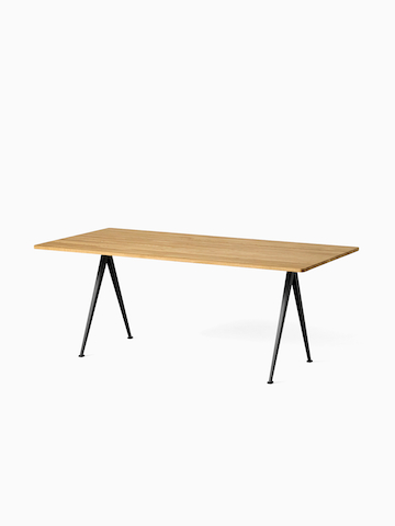 A front angle view of the Pyramid Table with overhang in Oak top and Black frame. Select to go to the Pyramid Table product page.